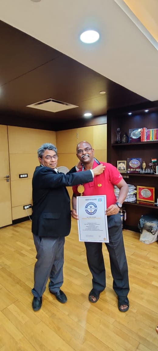 Bobba Ravinder Reddy receiving a certificate and medal at a GAIL office presentation