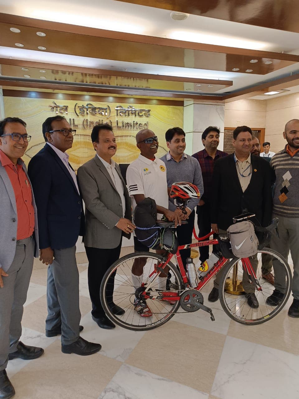 Bobba Ravinder Reddy with his bicycle and GAIL India Limited officials in the lobby