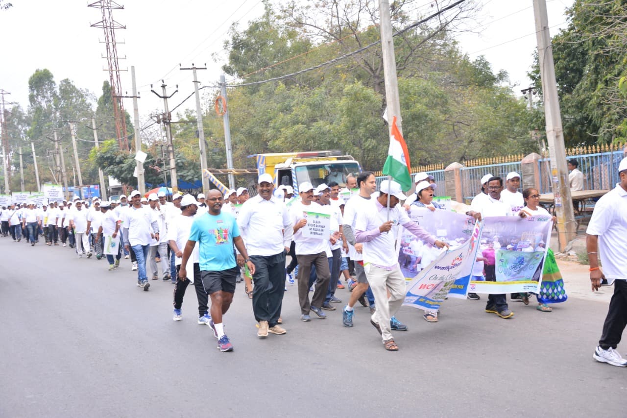 Large crowd marching with banners at a World Health Day Walkathon