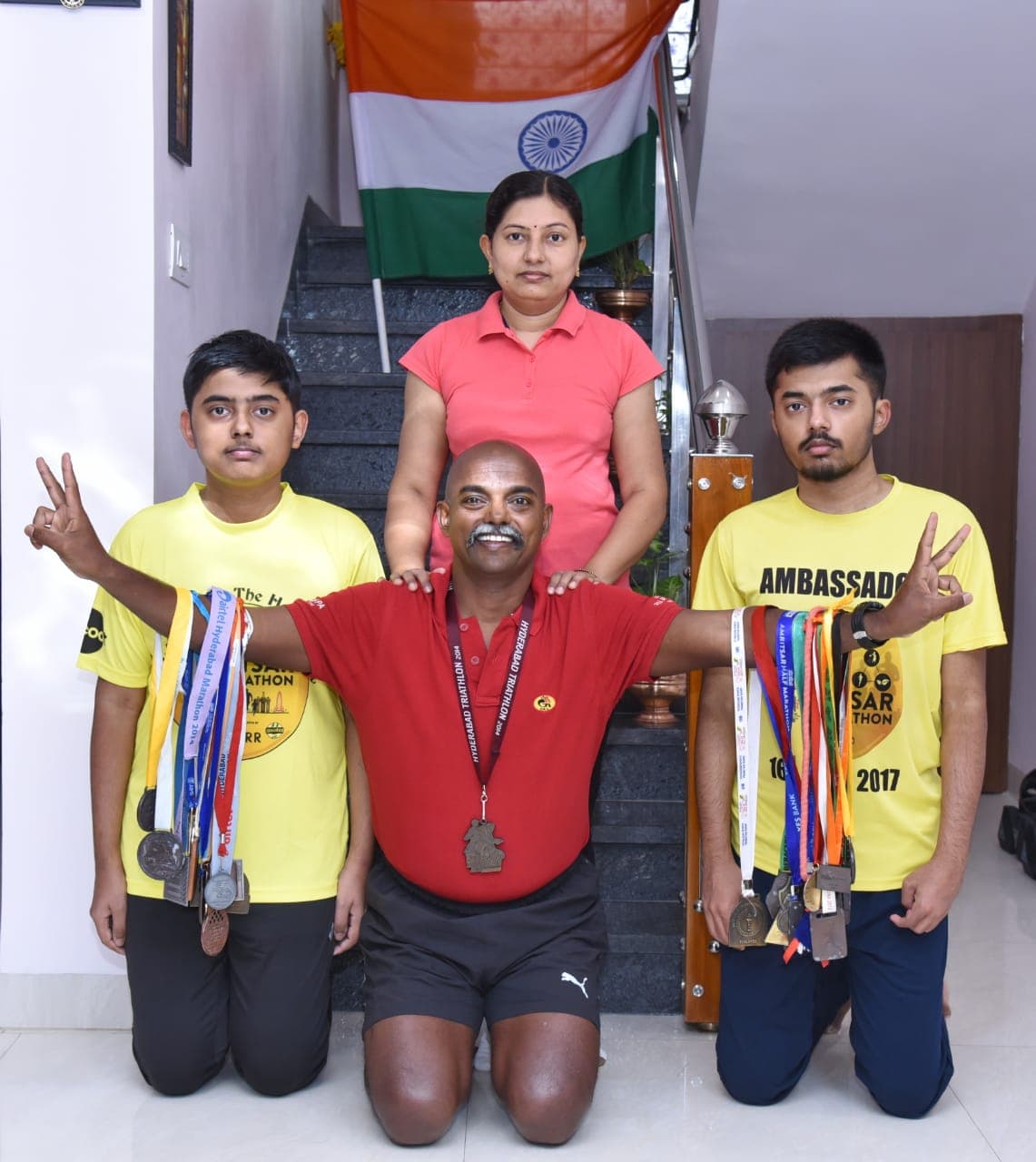 Bobba Ravinder Reddy and family displaying an array of marathon medals