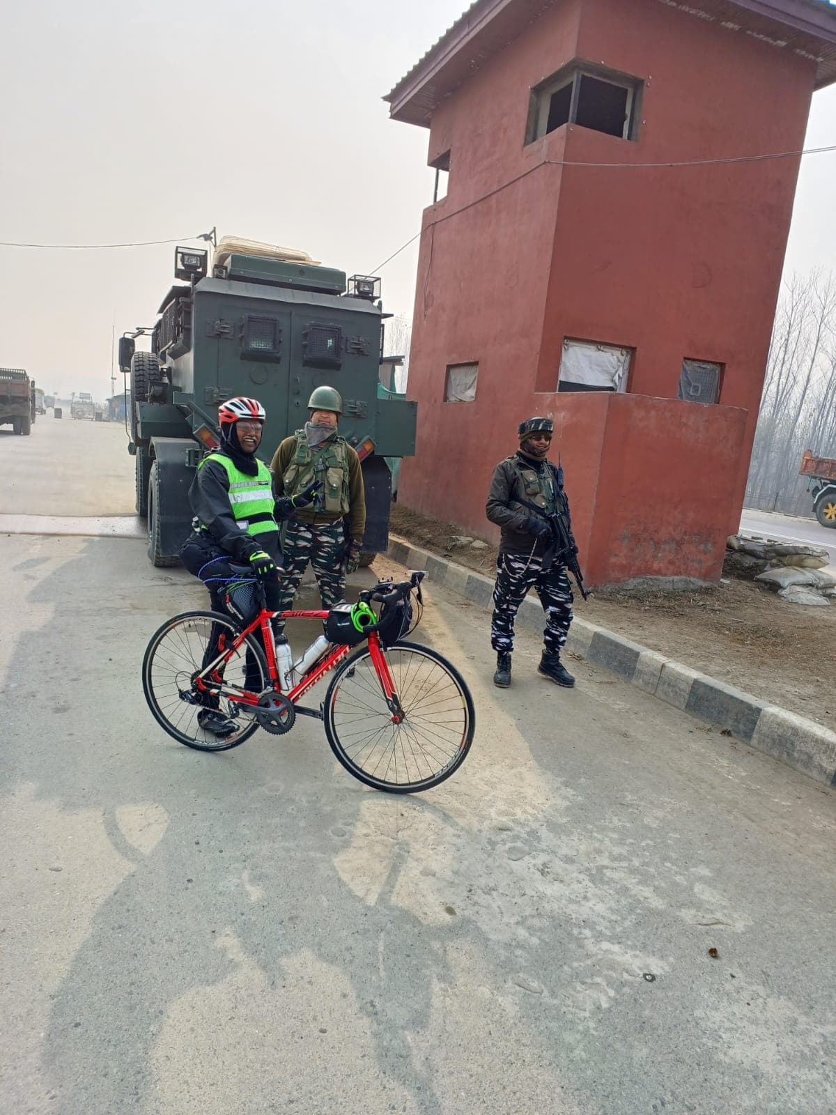 Bobba Ravinder Reddy posing with security personnel and an armored vehicle beside a watchtower in Kashmir