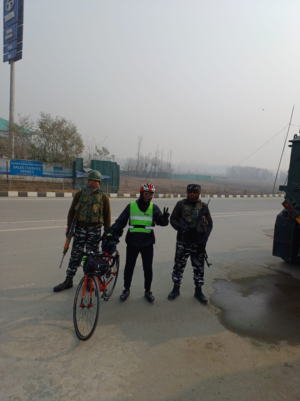 Bobba Ravinder Reddy posing with armed security personnel on a Kashmir highway