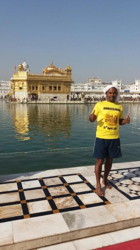 Bobba Ravinder Reddy standing on the marble courtyard in front of the Golden Temple, Amritsar